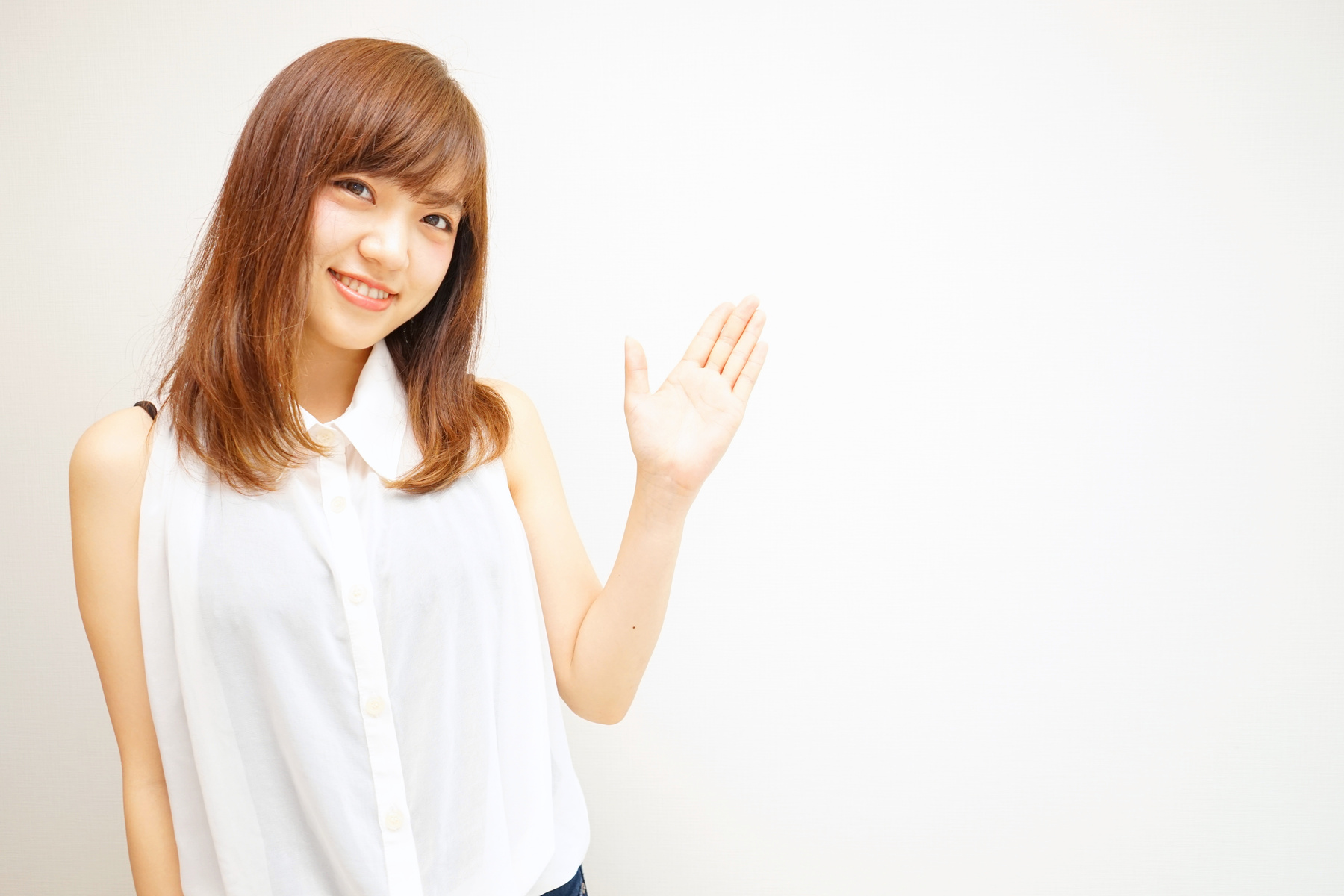 Young Japanese woman pointing something with smile